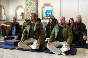 Makpon Jesse Grimes and others practice with the Vajradhara thangka after its installation at the Stupa